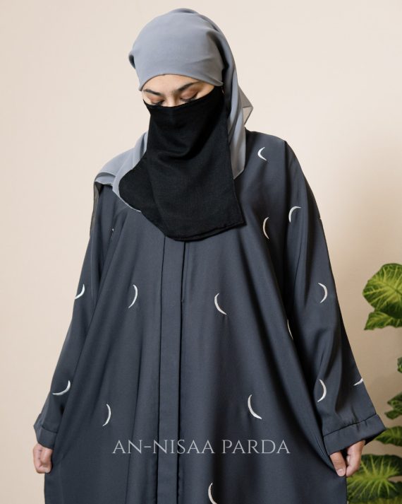 Close-up of crescent moon embroidery on gown fabric