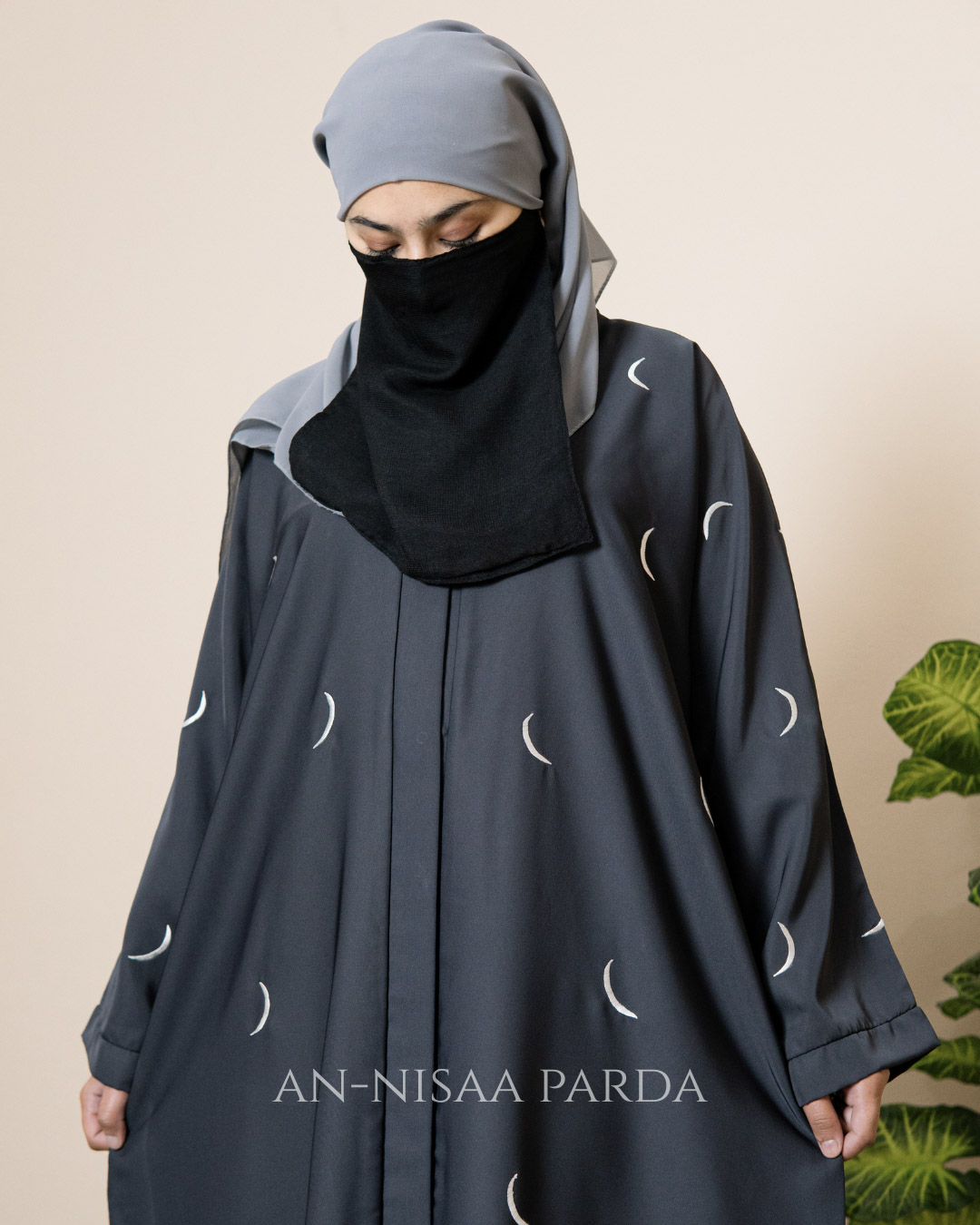 Close-up of crescent moon embroidery on gown fabric