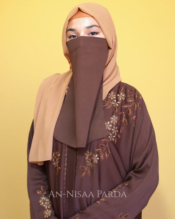 Full-length gown with floral vine embroidery on sleeves, accented with decorative DMC stones, embroidery extending from sleeves toward shoulder.