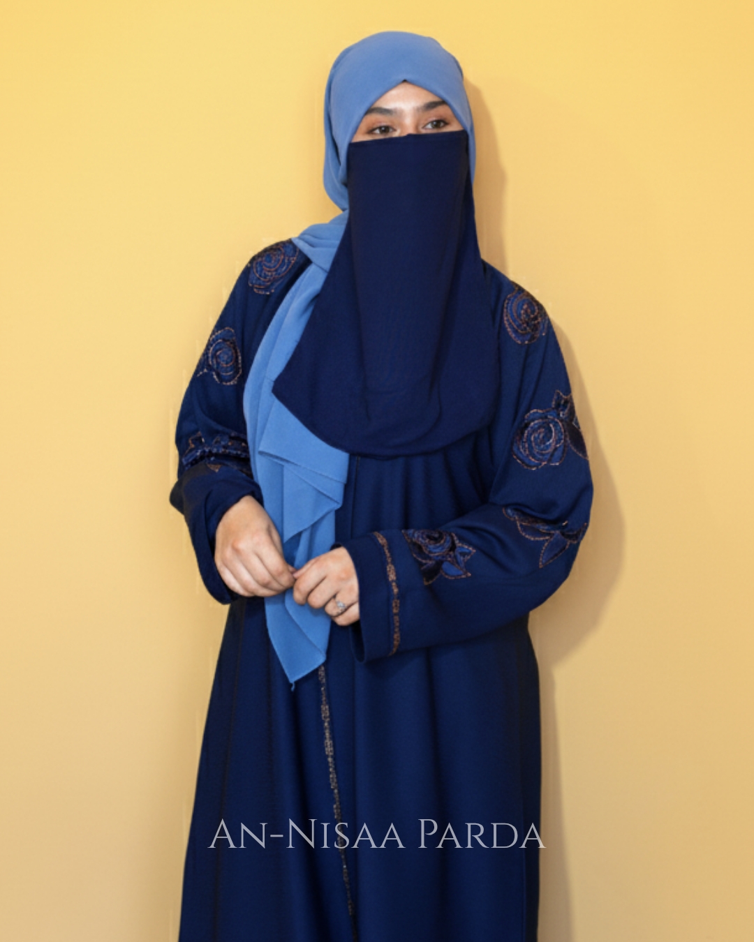 Upper body view of model wearing rosette embroidered gown, showing fit and sleeve embroidery.