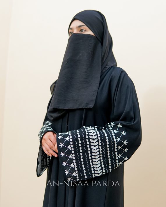 Side view of abaya highlighting floral vine embroidery on sleeves
